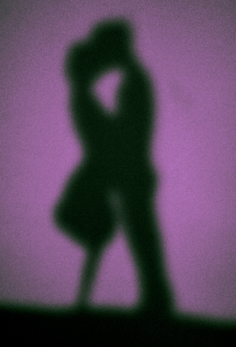 the silhouette of A guy and girl kissing it's a light painting by igor and andre artist danny roberts from his Series on love