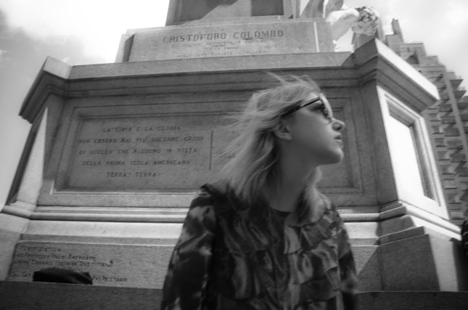 black and white Julia Frakes black and white photo of writer, blogger, stylist editor Bunny Bisous Julia Frakes sitting in front of Cristoforo Colombo Statue & Monument