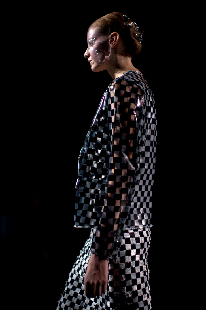 Anrealage Spring 2012 a Profile view of a Fashion model walking in a Black and Clear Checked Dress from Anrealage dress with a bubble mask taking by Artist Danny Roberts during Tokyo Fashion Week Spring 2012