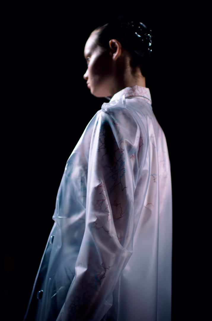 Anrealage Spring 2012 Fashion Artist Danny Roberts Photo of the profile of a model walking in a Clear Anrealage dress raincoat in the Collection from Tokyo Fashion Week 2012