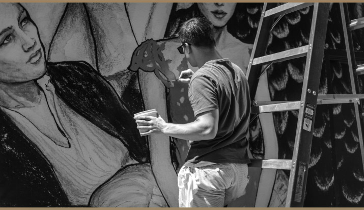 Danny Painting photo by Nick Bowser Photographer Nick Bowser photo of Fashion Artist Danny Roberts standing Painting details on Tiffanys store mural in soho new york